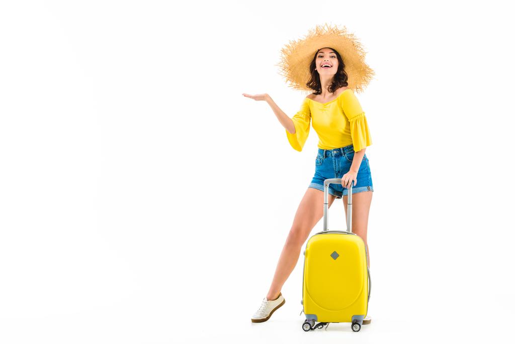 woman with luggage showing something with hand - Photo, Image