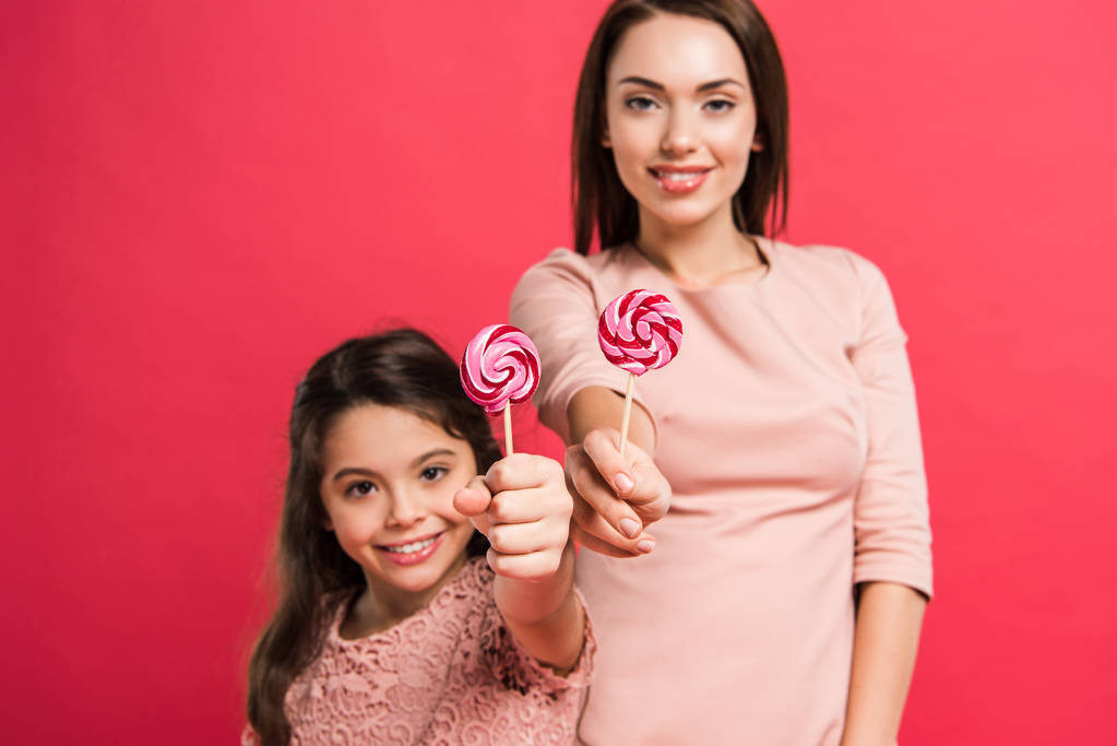 Mother and daughter showing lollipops - Photo, Image