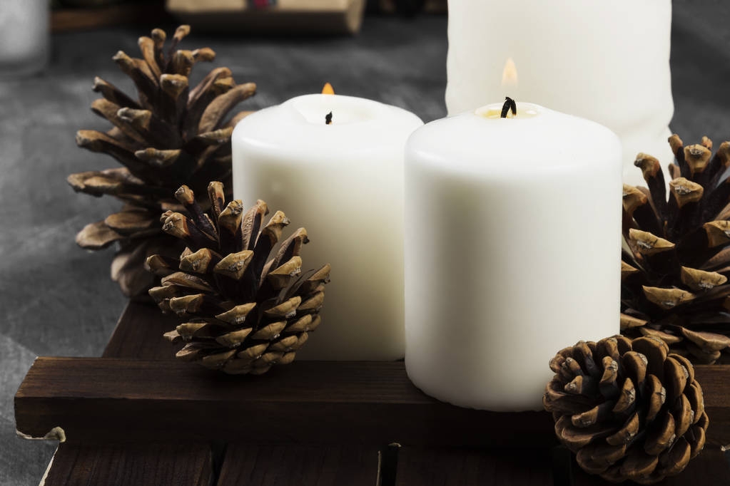 Bougies allumées et attributs de Noël sur un fond sombre
 - Photo, image