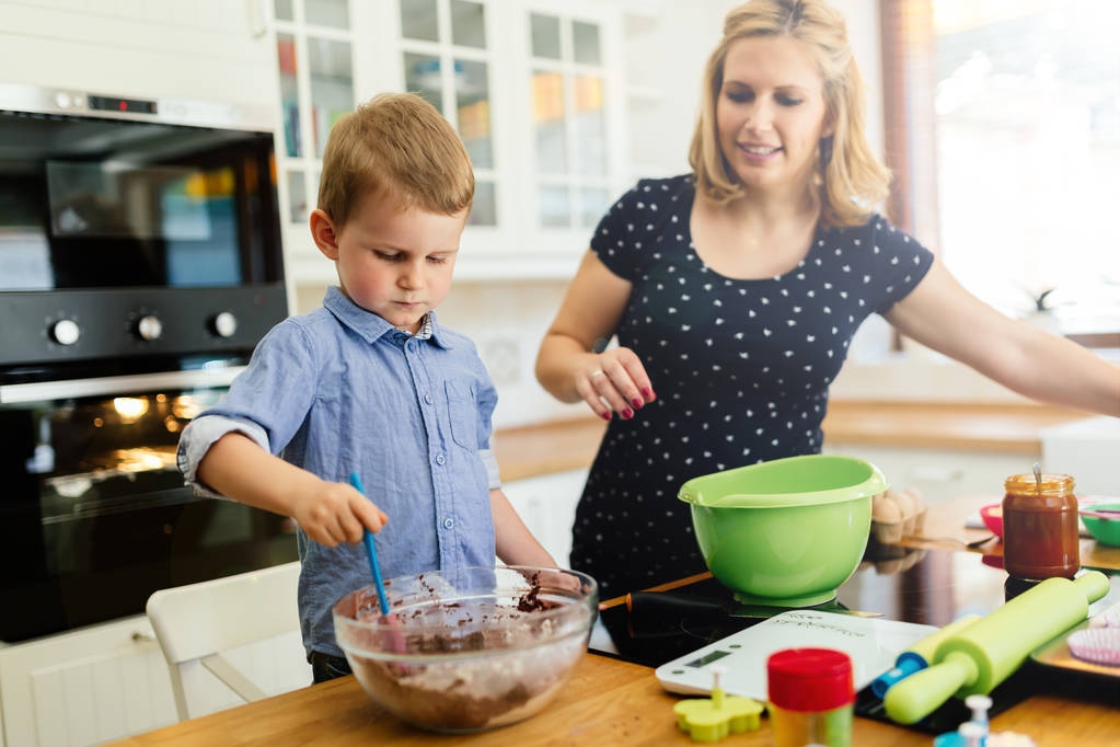 Mãe e criança preparando biscoitos
 - Foto, Imagem