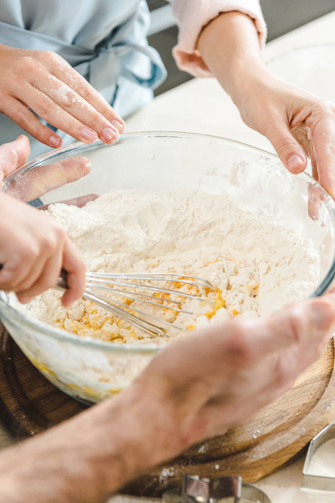 family hands mixing dough - Photo, Image