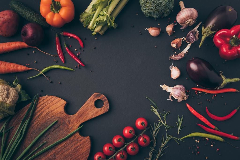 top view of different vegetables and cutting board on a table - Photo, Image