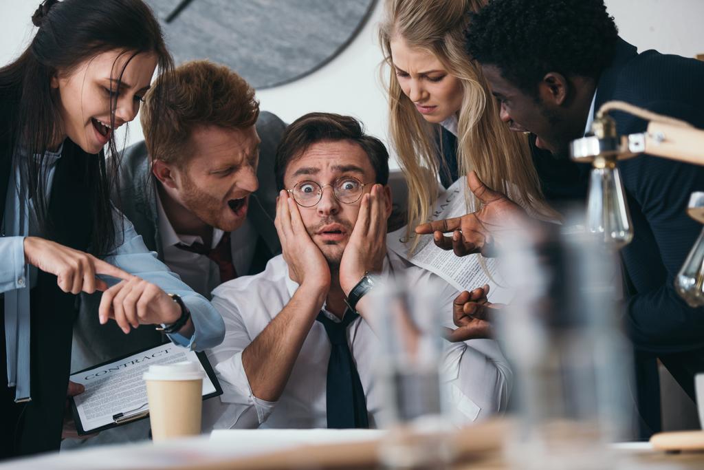 businessman having trouble with deadline while colleagues shouting at him - Photo, Image
