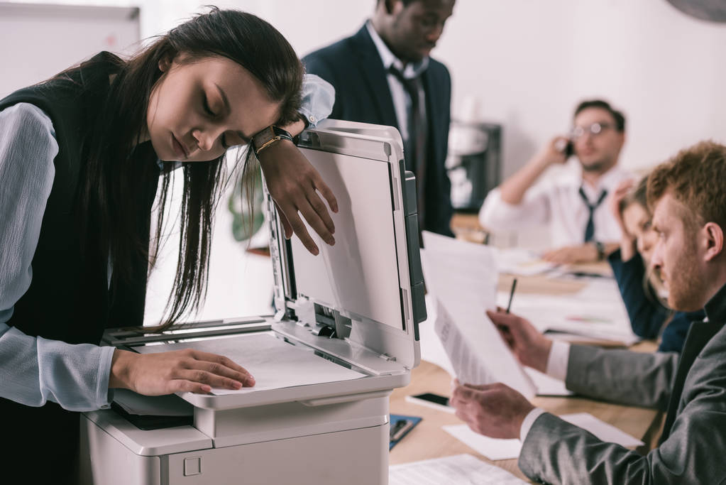 exhausted zombie like businesswoman sleeping on copier at office - Photo, Image