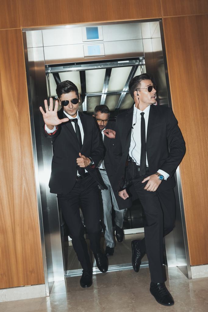bodyguard obstructing paparazzi when celebrity going out from elevator  - Photo, Image