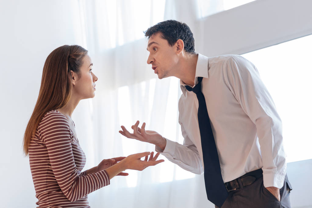 Irritated angry man giving arguments to his emotional wife - Photo, Image