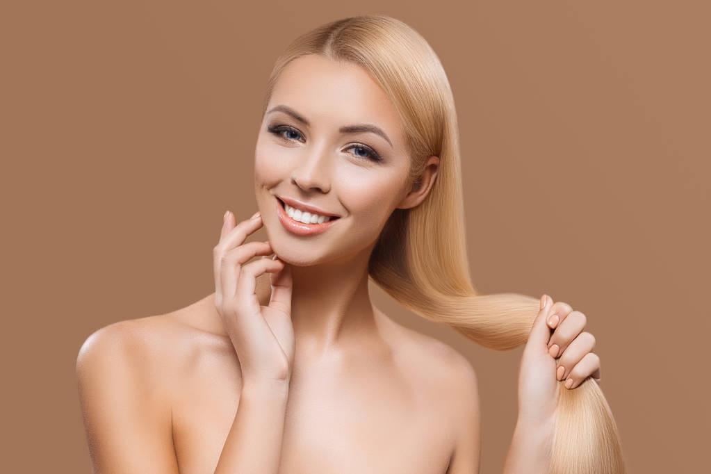 portrait of beautiful blonde long hair girl isolated on beige - Photo, Image