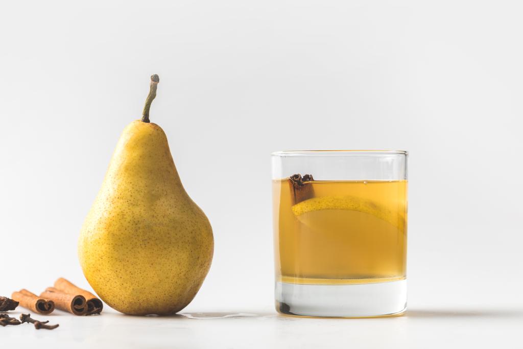 glass of delicious pear cider with cinnamon on white - Photo, Image