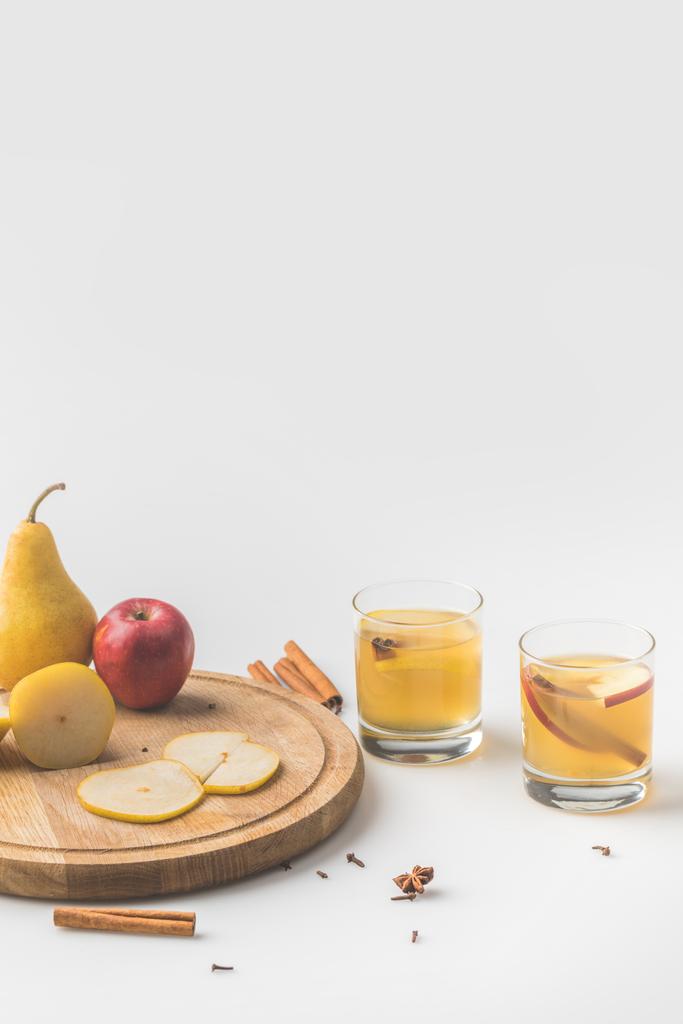 glasses of cider with apple and pear on wooden board on white - Photo, Image