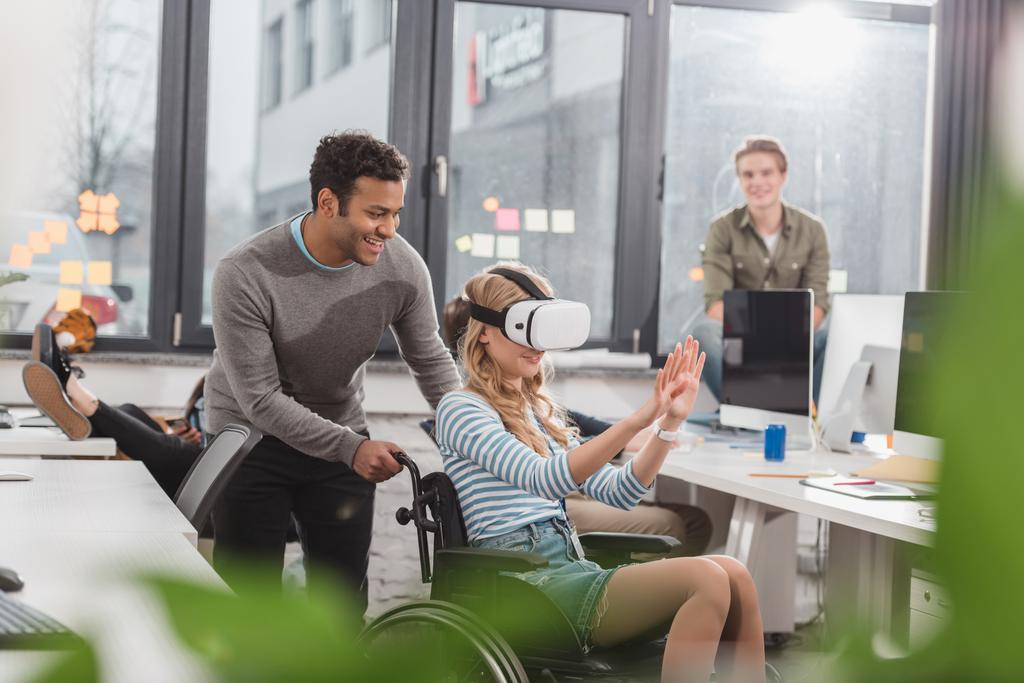 vrouw in rolstoel met behulp van virtual reality bril op moderne kantoor - Foto, afbeelding