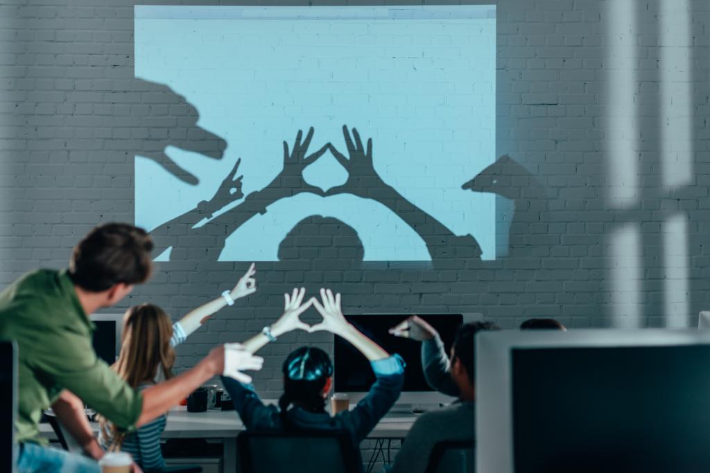 young people playing with shadows after work in modern office - Photo, Image