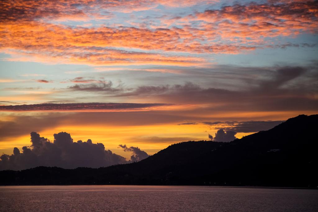 kaunis auringonlasku merimaisema pilvisen taivaan alla
 - Valokuva, kuva