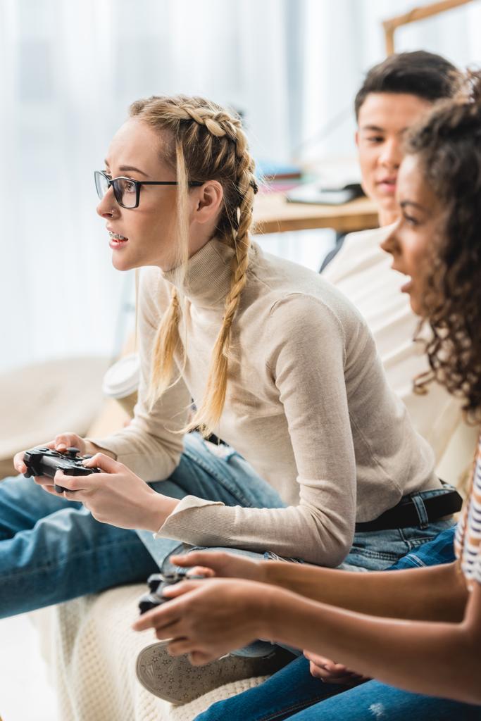 multiethnic girls playing video game at home  - Photo, Image