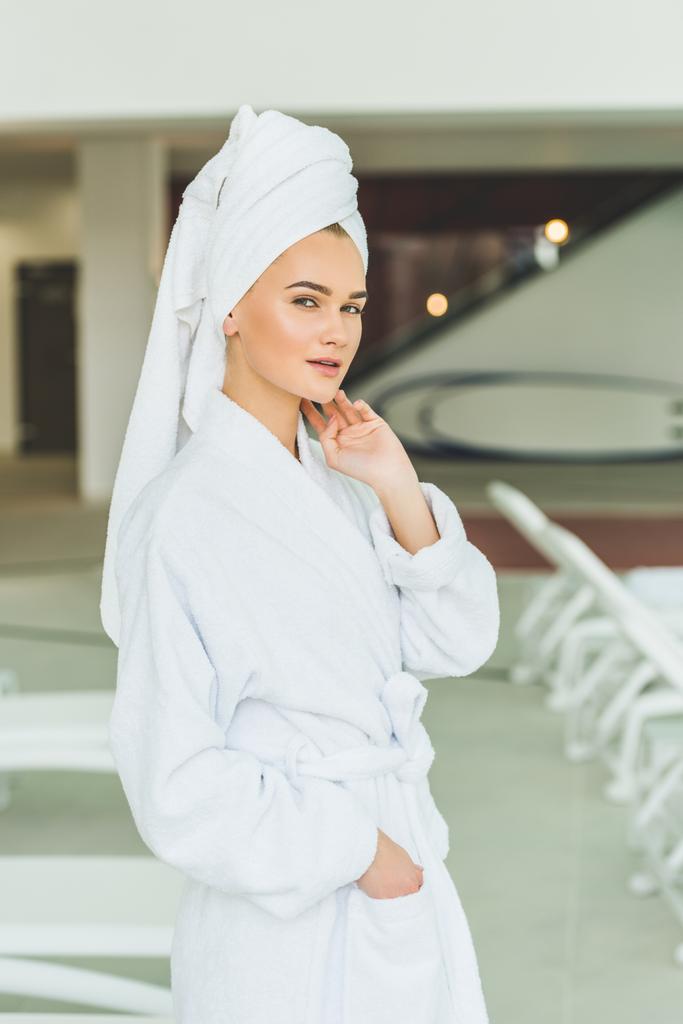 beautiful young woman in bathrobe at spa salon - Photo, Image