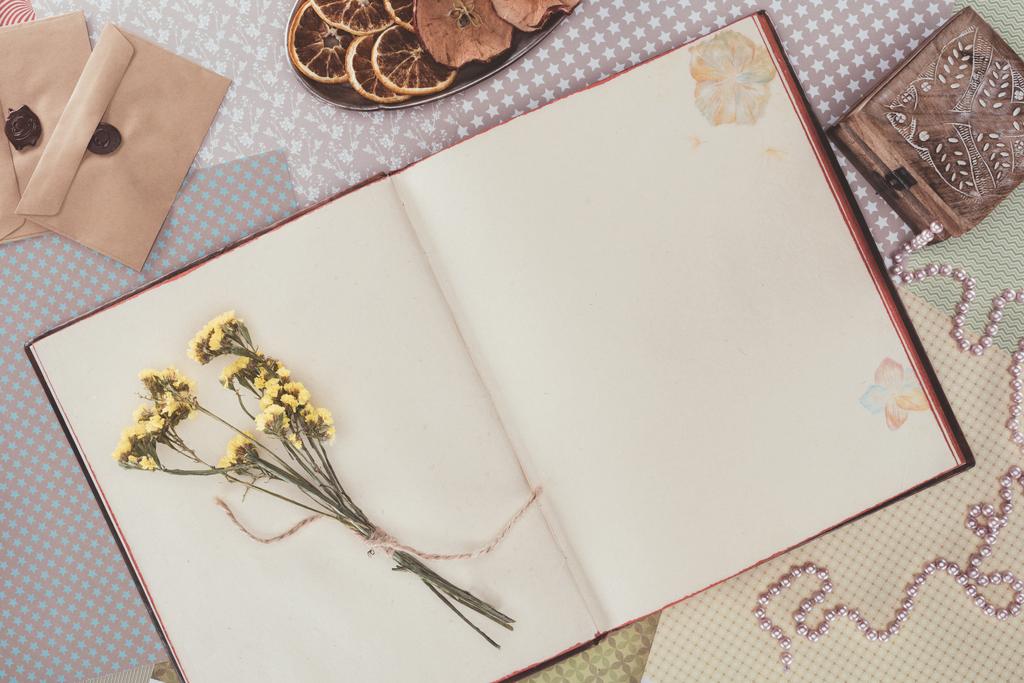 top view of opened book with flowers and copy space - Photo, Image
