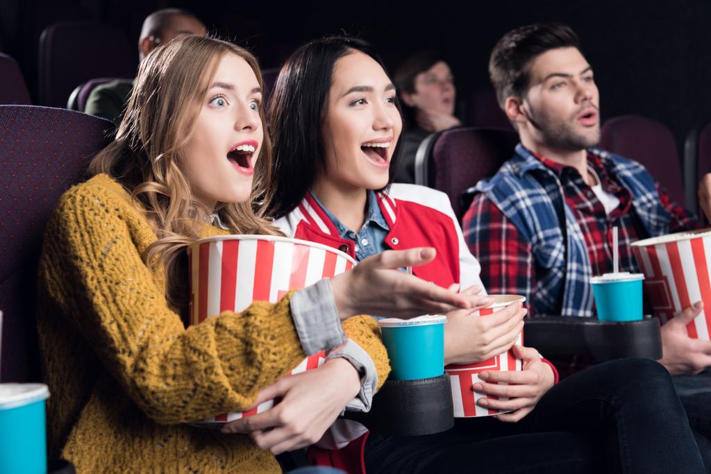ενθουσιασμένος παρέα με ποπ κορν και σόδα παρακολουθώντας την ταινία στο σινεμά - Φωτογραφία, εικόνα