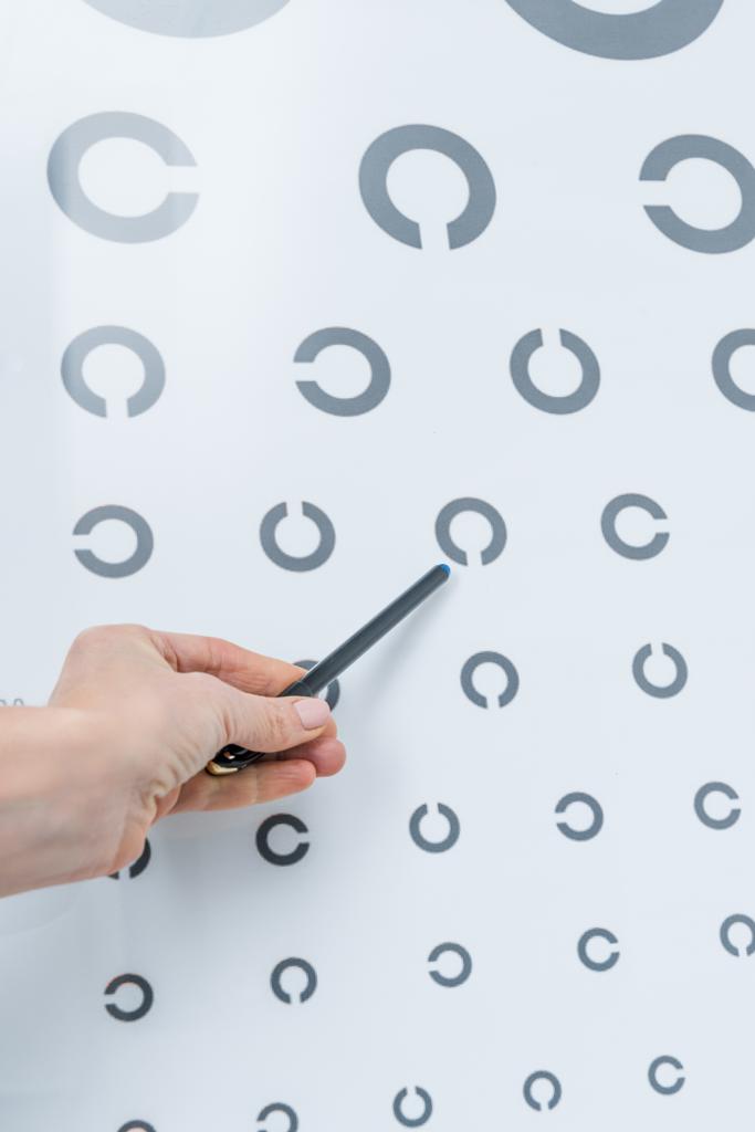 cropped view of oculist pointing at eye chart  - Photo, Image