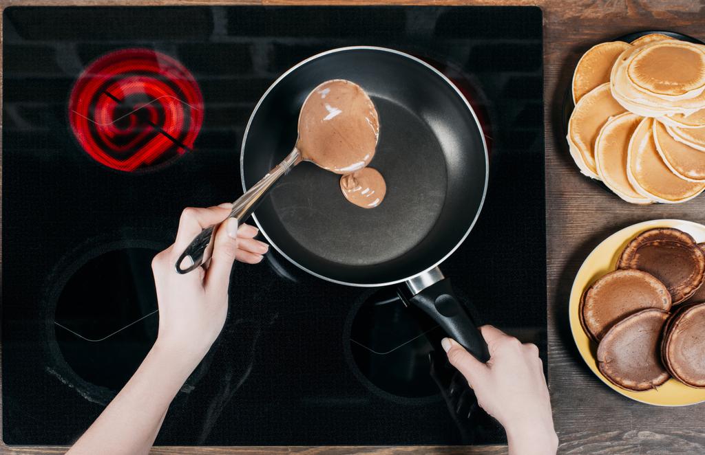 cropped shot of woman frying chocolate pancakes - Photo, Image