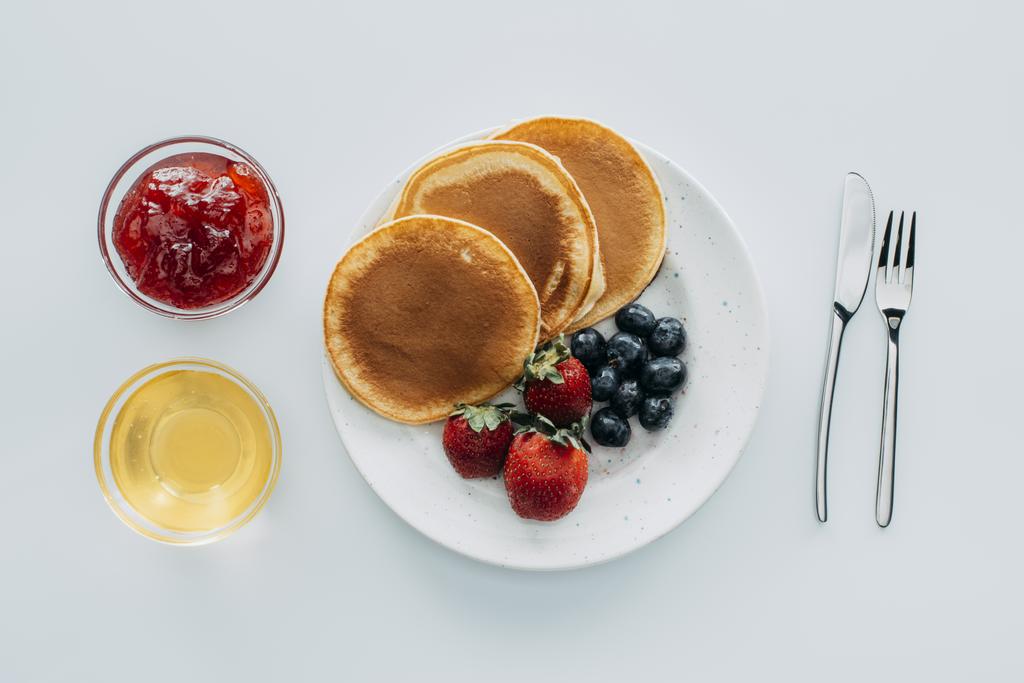 top view of sweet pancakes with berries on white table - Photo, Image