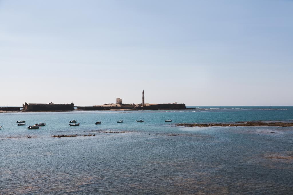 Scenic view of seascape with pier and boats under blue clear sky, Cadiz. - Photo, Image