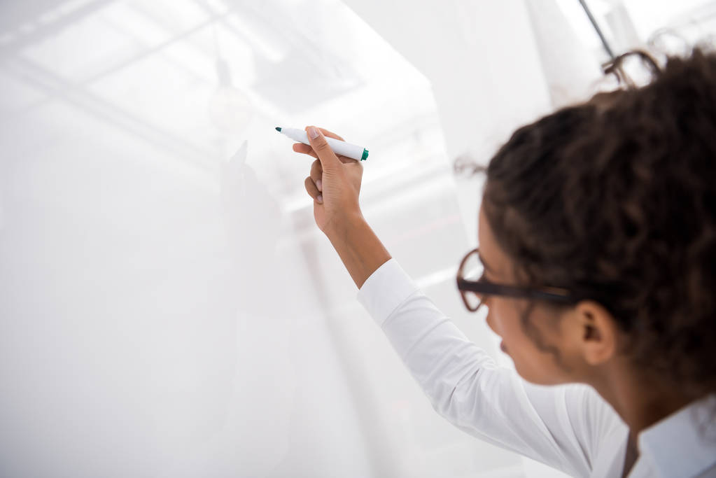young african american teenager writing on white board - Photo, Image