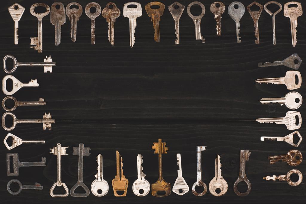 top view of vintage keys frame on black table - Photo, Image