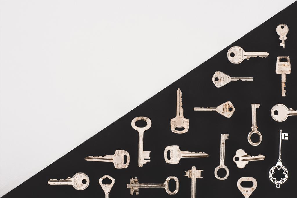 top view of different vintage keys over black and white background - Photo, Image