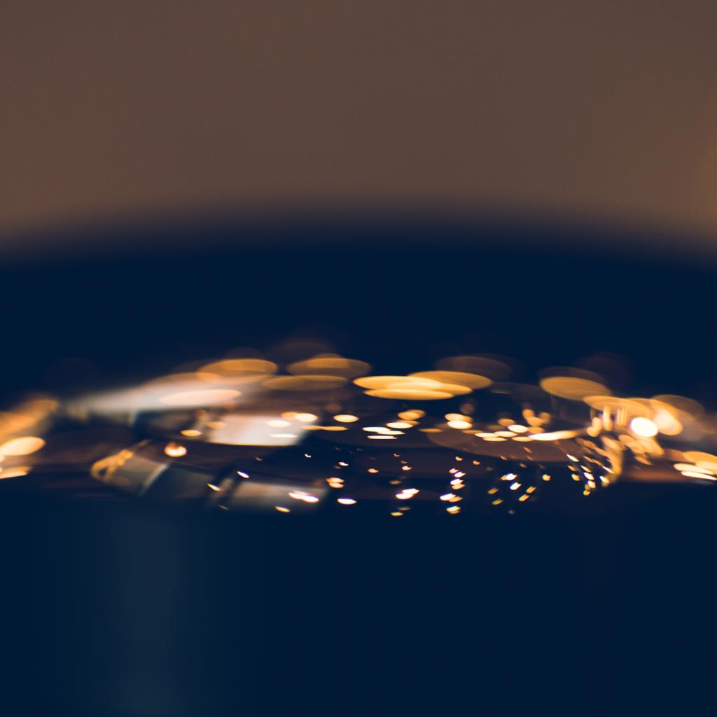 close-up shot of golden lights reflecting in glass of camera lens - Photo, Image