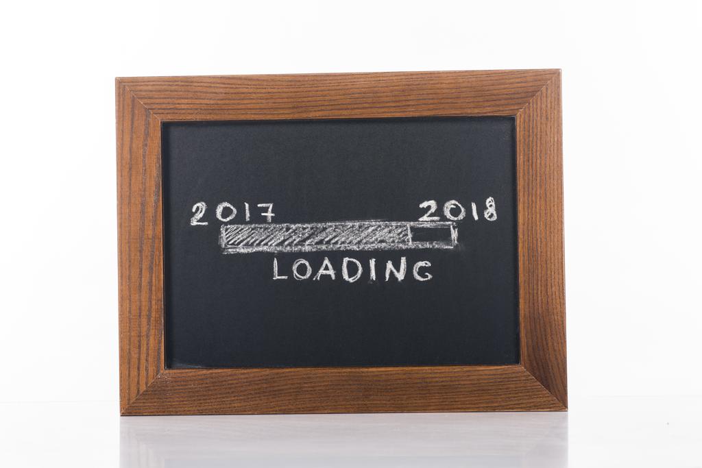 close up view of chalkboard with 2017 to 2018 loading lettering isolated on white - Photo, Image