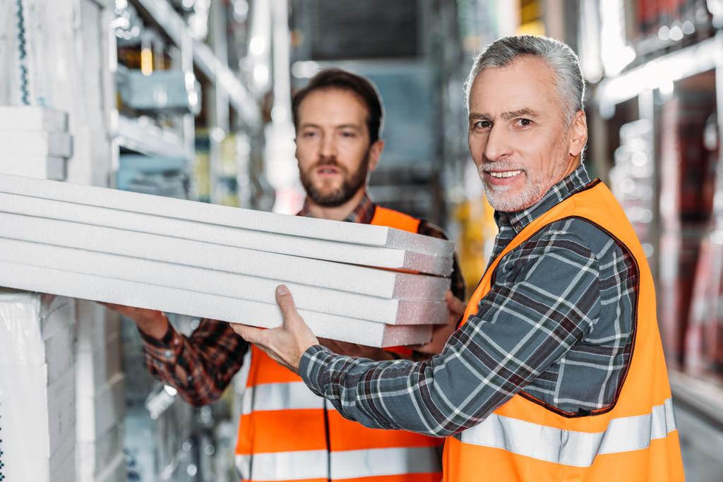 two male workers holding styrofoam in shipping stock - Photo, Image