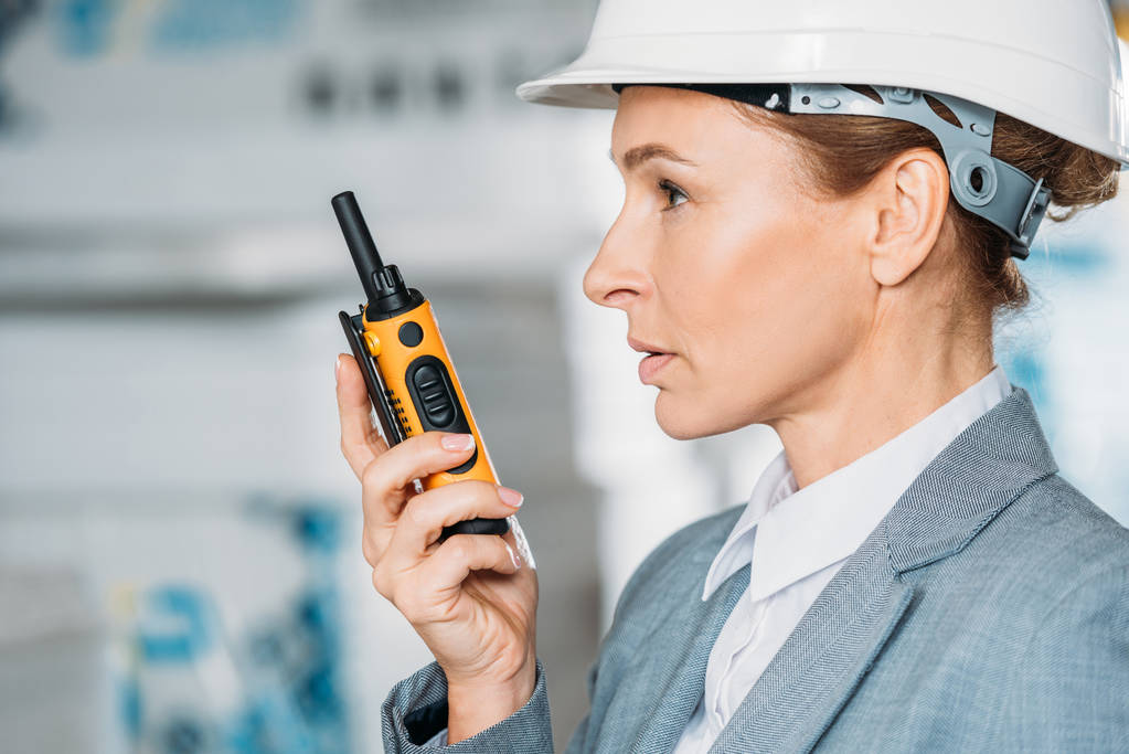 female inspector in helmet with walkie talkie in shipping stock - Photo, Image