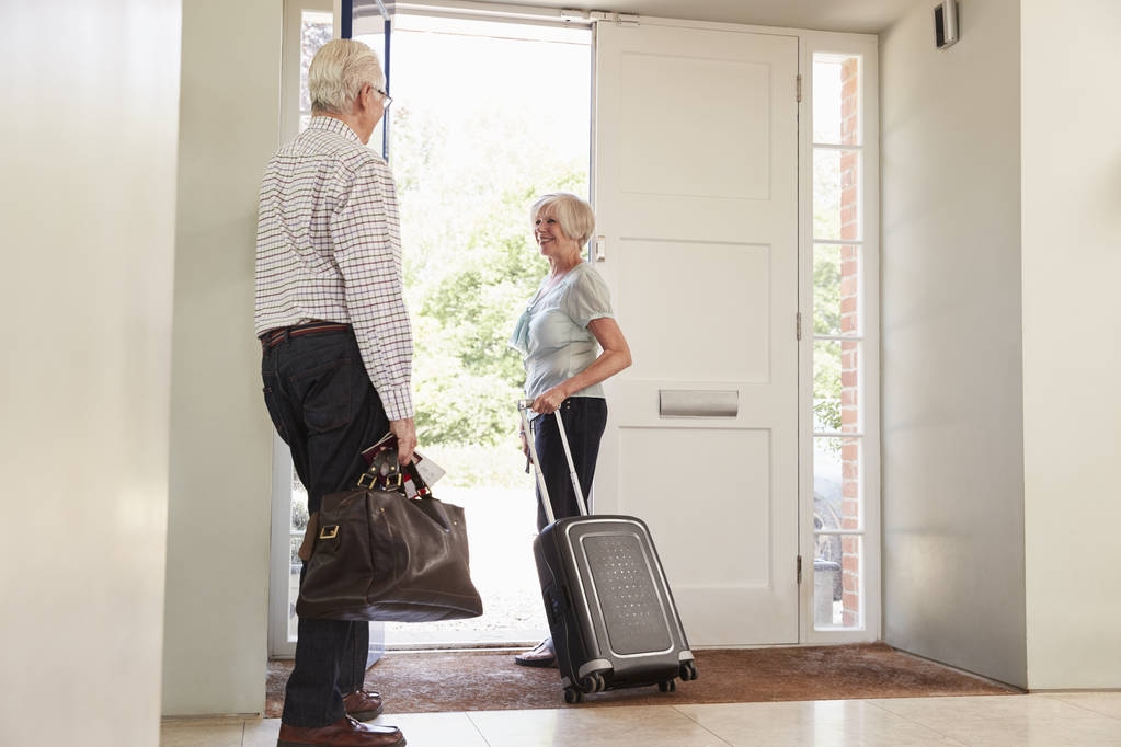 Senior couple with luggage leaving home for a holiday - Photo, Image