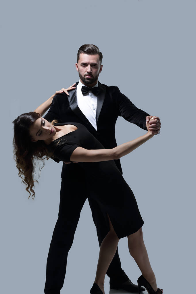Portrait Of Young Couple Dancing Over Grey Background - Photo, Image