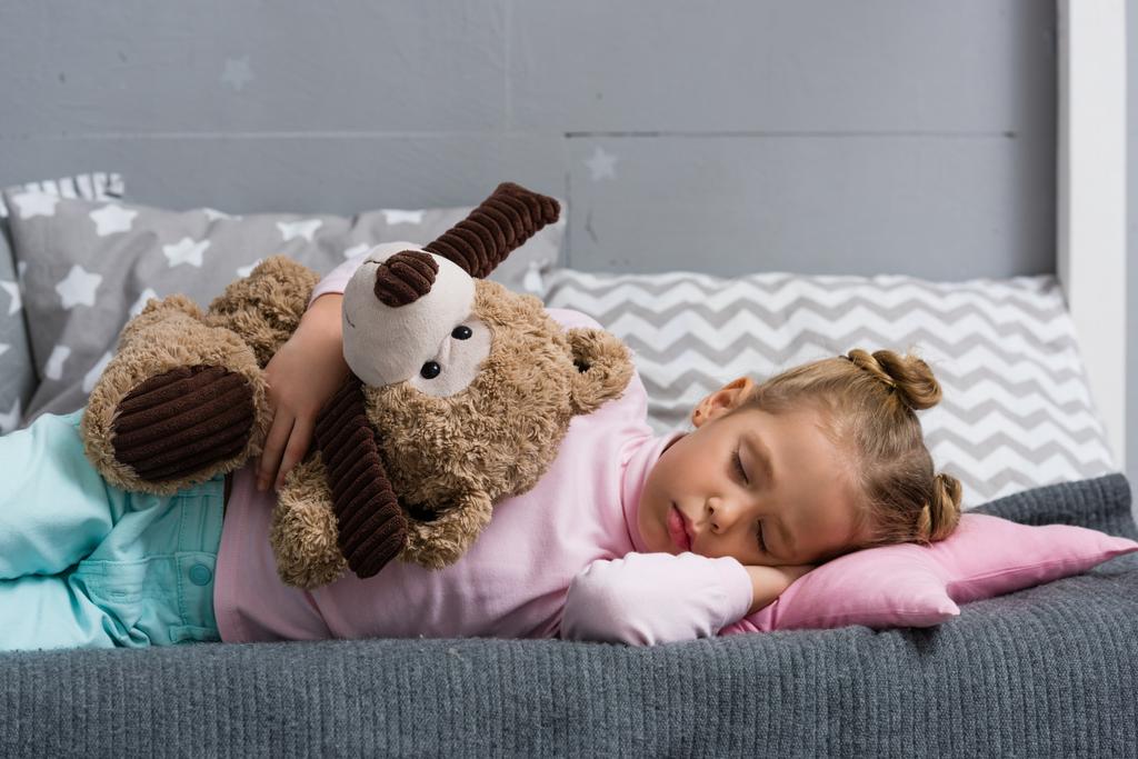 adorable little kid sleeping on couch with teddy bear - Photo, Image