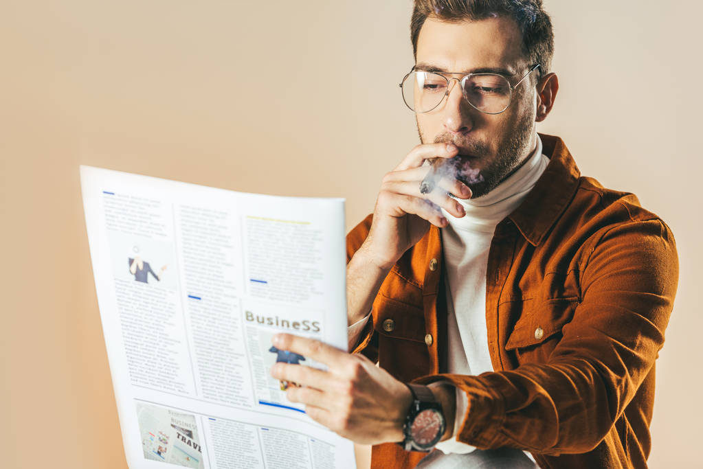πορτρέτο του επιχειρηματία με πούρο διαβάζοντας εφημερίδα που απομονώνονται σε μπεζ - Φωτογραφία, εικόνα