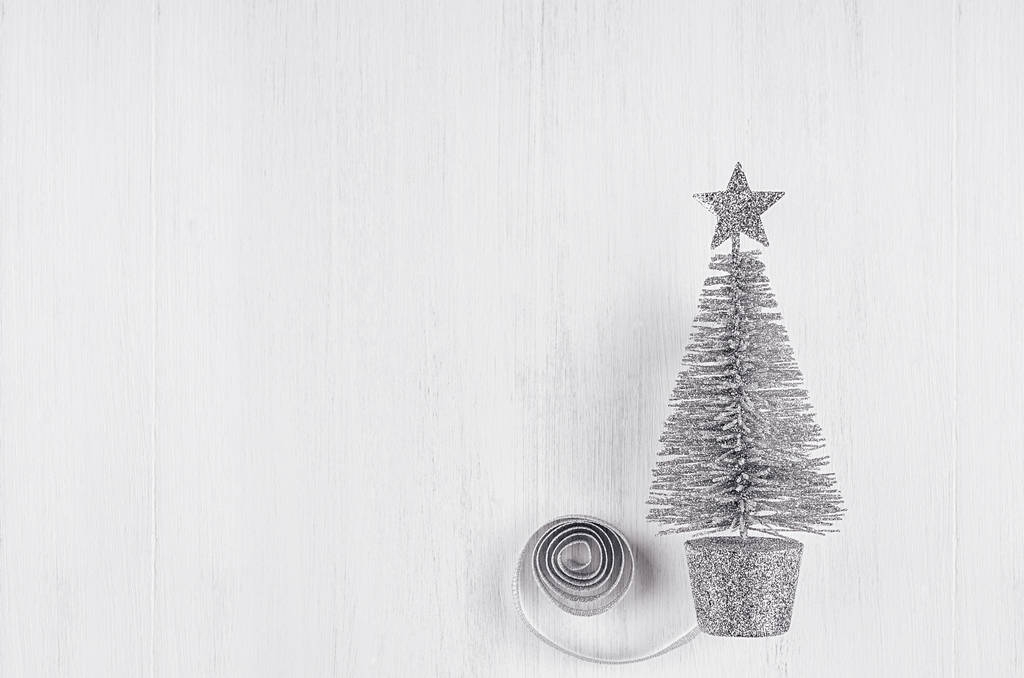 Silvery christmas tree on white wood background. Christmas decoration, copy space. - Photo, Image
