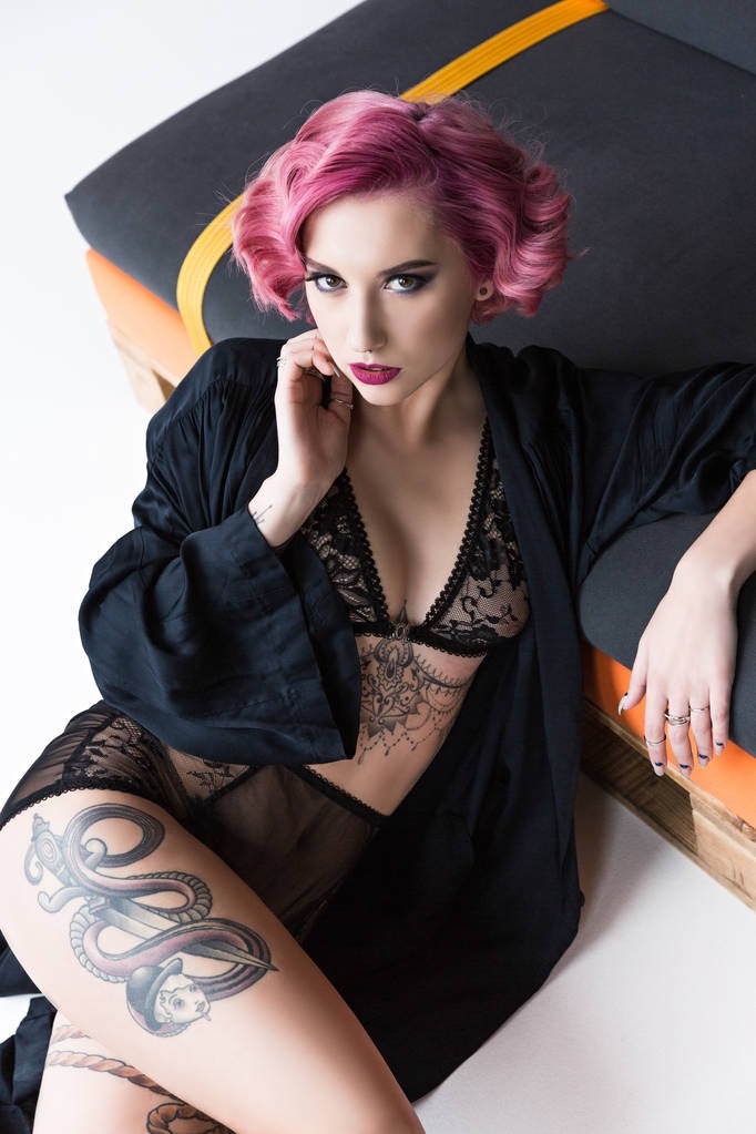 соблазнительная татуированная девушка в прозрачном нижнем белье позирует на диване
 - Фото, изображение