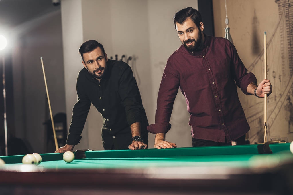 successful handsome men playing in pool at bar - Photo, Image