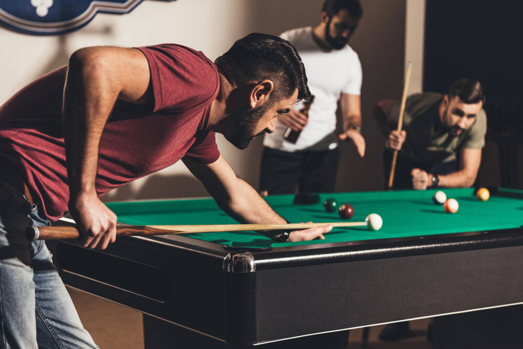 company of handsome men playing in pool  - Photo, Image
