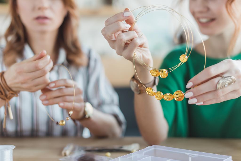 young concentrated women making chaplets in handmade workshop - Photo, Image