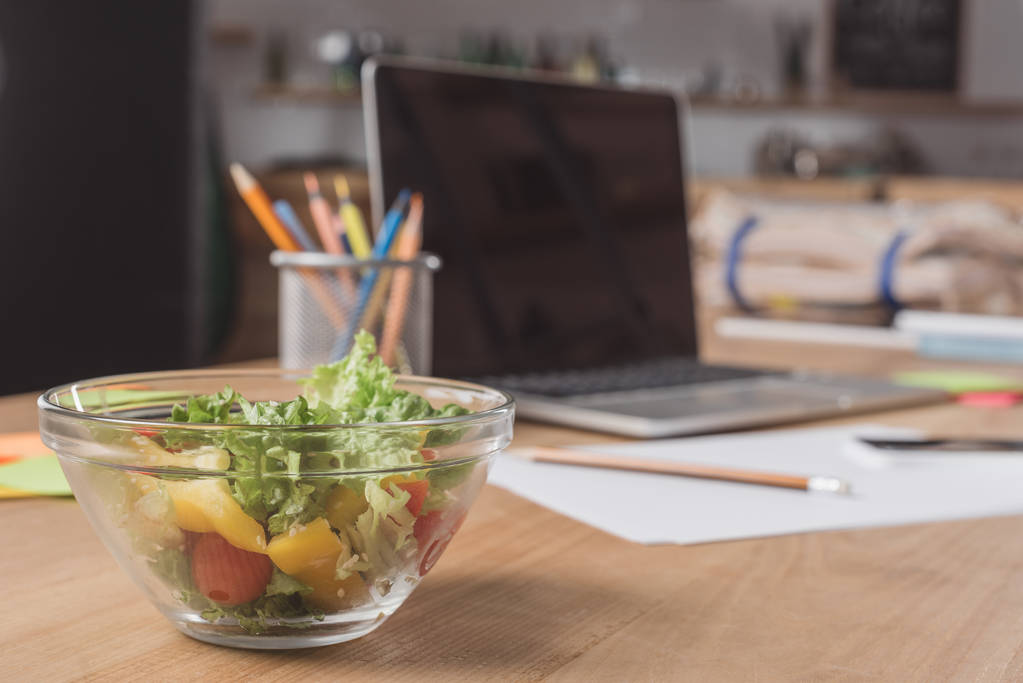 close-up shot of workplace with laptop and healthy salad - Photo, Image