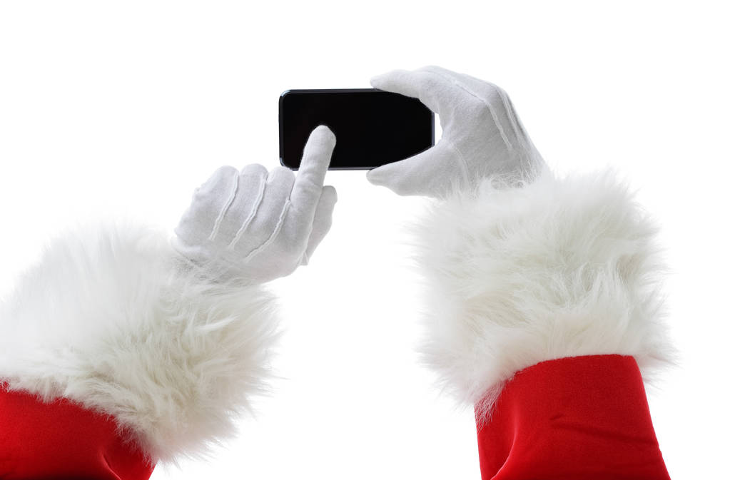 Karácsonyi concept shot télapó gazdaság egy fekete szúró telefon, mutatja, hogy a kamerába - Fotó, kép