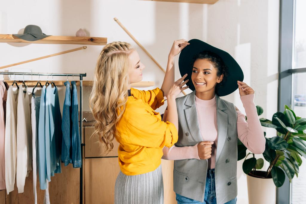 young stylish shopping buddies spending time in clothing store - Photo, Image