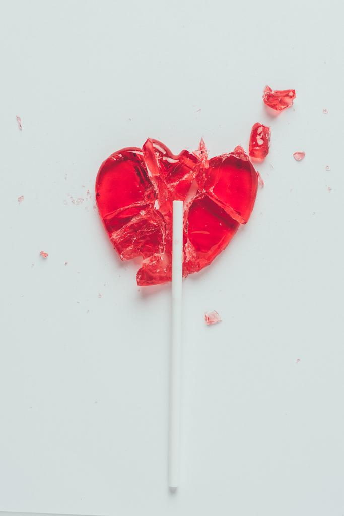 top view of broken heart shaped lollipop isolated on white, valentines day concept - Photo, Image