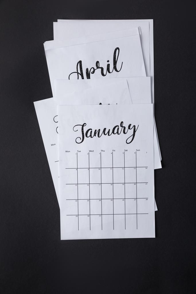 top view of arranged parts of paper calendar isolated on black - Photo, Image