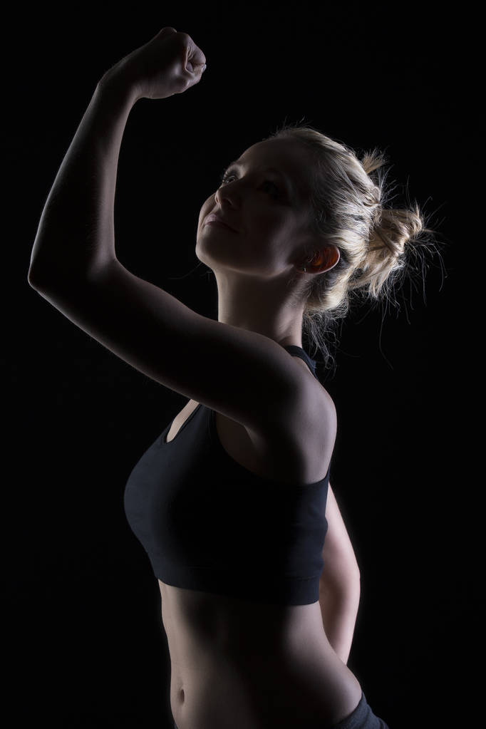 Beautiful fit and motivated blond woman portrait in black top gi - Photo, Image