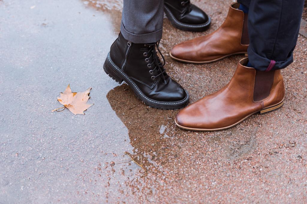 cropped image of female and male legs in autumn shoes - Photo, Image