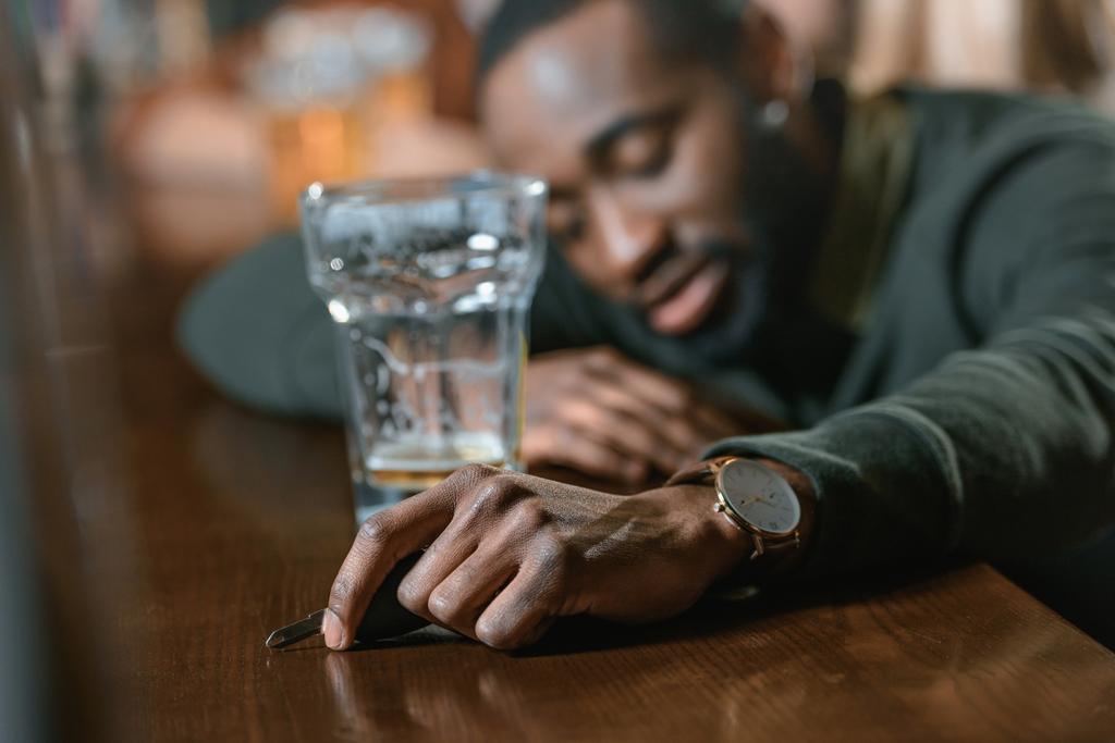 very drunk african american man with automobile keys at bar - Photo, Image