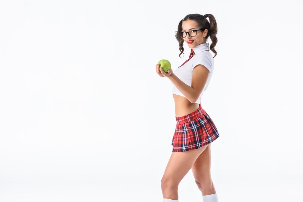 若いセクシーな女子高生は白で隔離グリーンアップルを保持 - 写真・画像