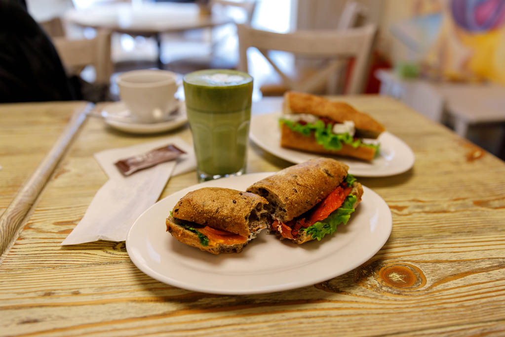 Salmon sandwich with matcha latte in the bakery, lunch - Photo, Image
